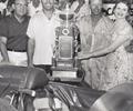 August 24 1957 Milwaukee Mile. L-R Car Owner Lindsey Hopkins, Chief Mechanic Jack Beckley & Winning Driver Jim Rathmann with the Leader Card Trophy
