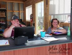 IRA Officials Tiffany Taylor and Kim Tennyson in the Wilmot Raceway Pit Sign in Booth
