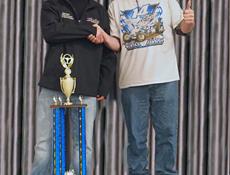 Ryan Zielski on stage with crew member and championship awards from the WingLESS Sprint category
