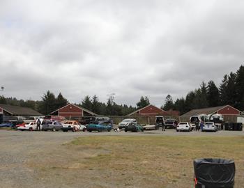 Several cars are in the pits at Redwood Acres Raceway.