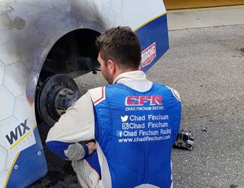 Chad Finchum surveys fire damage at Iowa Speedway.