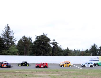 The Legends division cars race into the third turn.