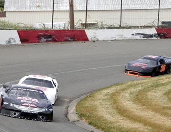 Several late models turning laps in practice.