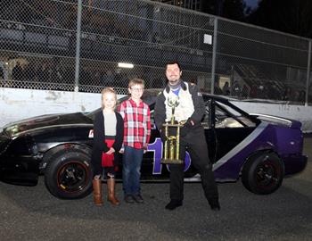 #16 Eric OFerrall poses with the trophy after winning the mini stock main event.