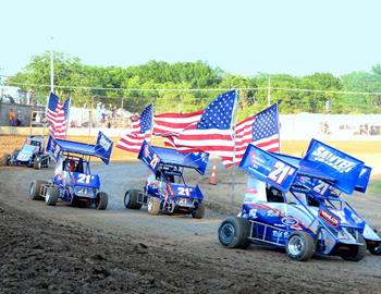 The Hinck family cars parade the American flag during the national anthem