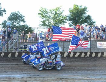 The Hinck cars carried the flag around the track during the national anthem