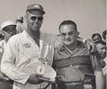 June 9, 1957 Milwaukee Mile. Jimmy Bryan receives the Leader Card Trophy from Bob Wilke for fast time. For years Bob / Leader Cards would sponsor the trophies at the Milwaukee Mile races for big cars, stock cars and midgets.
