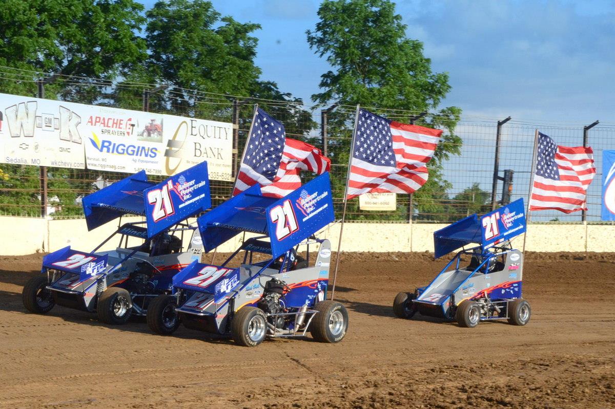 The Hinck cars carried flags around the track during the national anthem