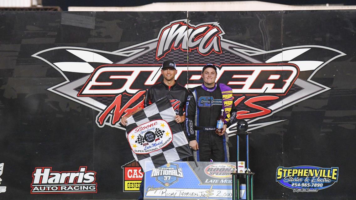 His convincing win in Monday’s Deery Brothers Summer Series main event made Ricky Thornton Jr. the first champion crowned at the 37th annual IMCA Speedway Motors Super Nationals fueled by Casey’s at Boone Speedway. At left is IMCA President Brett Root. (Photo by Tom Macht, www.photofinishphotos.com)