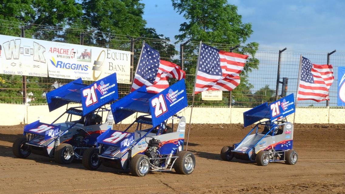 The Hinck cars carried flags around the track during the national anthem