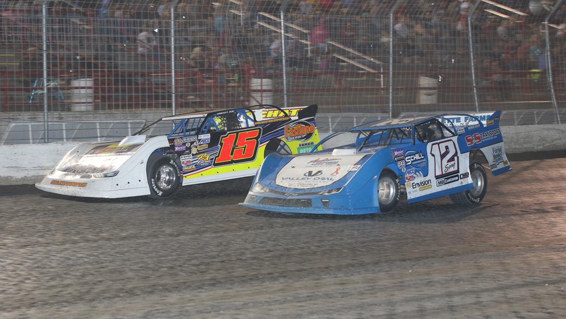 Donny Schatz (15) and Brad Seng (12) race for the lead during the NLRA Late Model feature at Red River Valley Speedway during the 2018 Outlaws event.