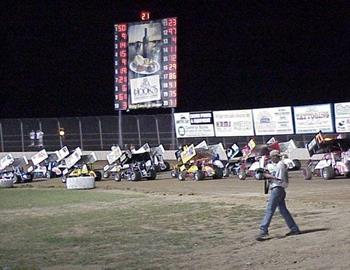 Three-wide under Lake Ozark Speedways scoreboard