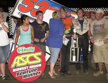 Jack Dover gets a kiss from his Mom in victory lane