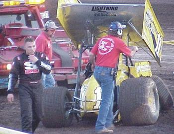 Foster Landon makes his way back to the pit area after a heat race tangle.