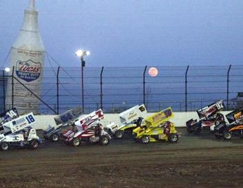 Full moon rises over a heat race at Lucas Oil Speedway