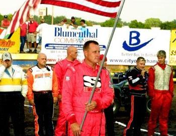 Danny Jennings holds the flag at opening ceremonies