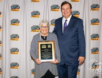 Deb Dennison accepts the Ralph Capitani Heritage Award from Bob Baker