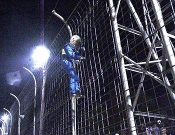 Dupuy celebrates by climbing the fence 