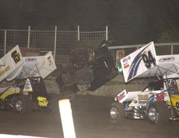 Nick Smith (15s) and Danny Wood (94) dodge a flipping Donnie Ray Crawford on the backstretch.