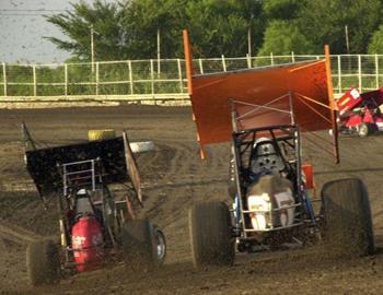 Danny Smith (5$) and David Speer (11) race off turn two