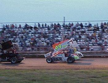 Heat race lines up in front of a large crowd