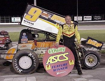 Gary Wright and his oil-soaked car in victory lane