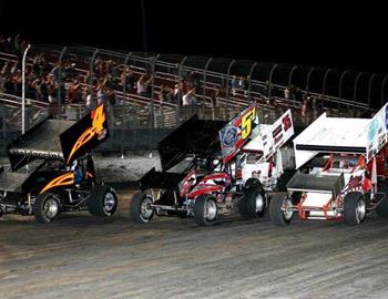 Johnny Miller (64J), Jimmy Brooks (51) and Eric Baldaccini (b4) lead the three-wide salute