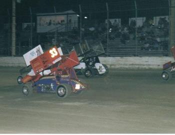 Racing three-wide down the straightaway.