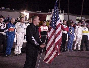 Danny Jennings holds the flag during opening ceremonies.