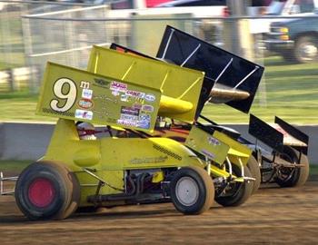 Eric Baldaccini (b4) races inside Dale McCarty (9m) entering turn three