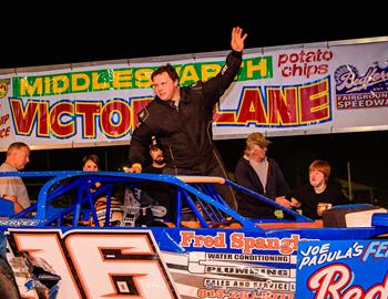 Clinton Hersh smiles waves in Victory Lane at Bedford Speedway on May 3.