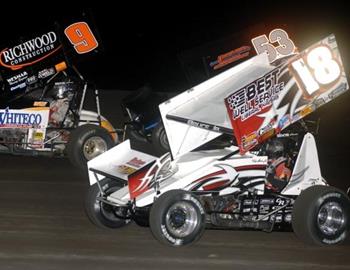 Tony Bruce, Jr. (18) races with Gary Wright (9) and Jack Dover (53) in the feature