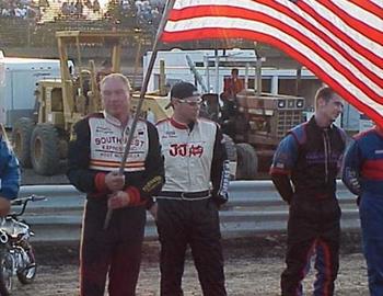 Gary Wright holds the flag during opening ceremonies