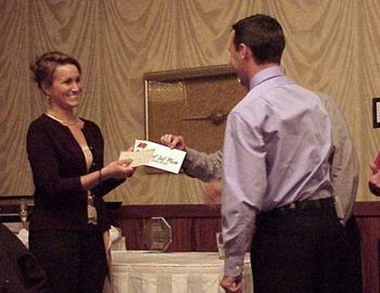 Travis Rilat hands his point fund check over to his new bride.