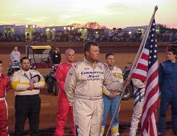 Kevin Ramey holds the American flag in opening ceremonies.