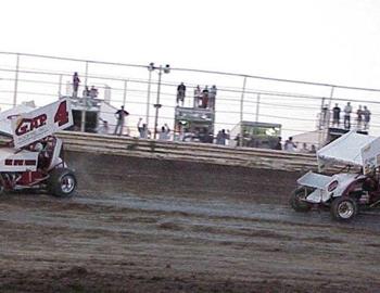 Darren Stewart (91) chases Jamie Passmore (4) in heat race action