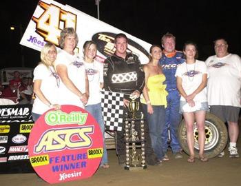 Jason Johnson joined by Daniel McMillin family members in victory lane