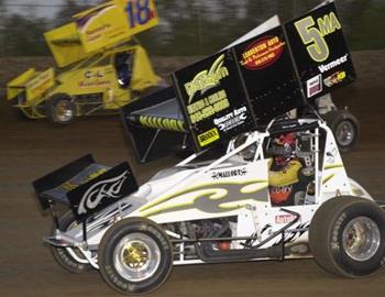 Mallory Armfield (5ma) races underneath Chris Walker (18w) and another car