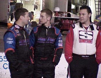 Teammates Jan Howard (left) and Lee Sowell (center) talk with Andy Shouse.