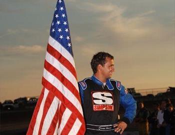 Darren Stewart holds the Flag at opening ceremonies