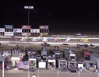 The field in three-wide formation down the backstretch