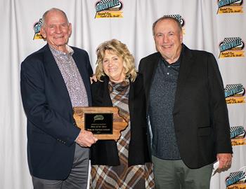 Dan and Carlene Afdahl accept their Fan of the Year Award from John McCoy
