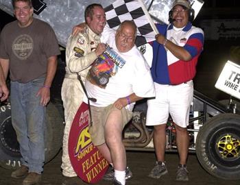 Mike McClelland show some leg in victory lane after his son Sean rallied from 17th for a last lap win