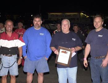 Tommie Estes, Jr. (left) presented the Wesmar brass, including Kelly Westphal, Bob Westphal and Dan Gentrup, with a plaque during opening ceremonies